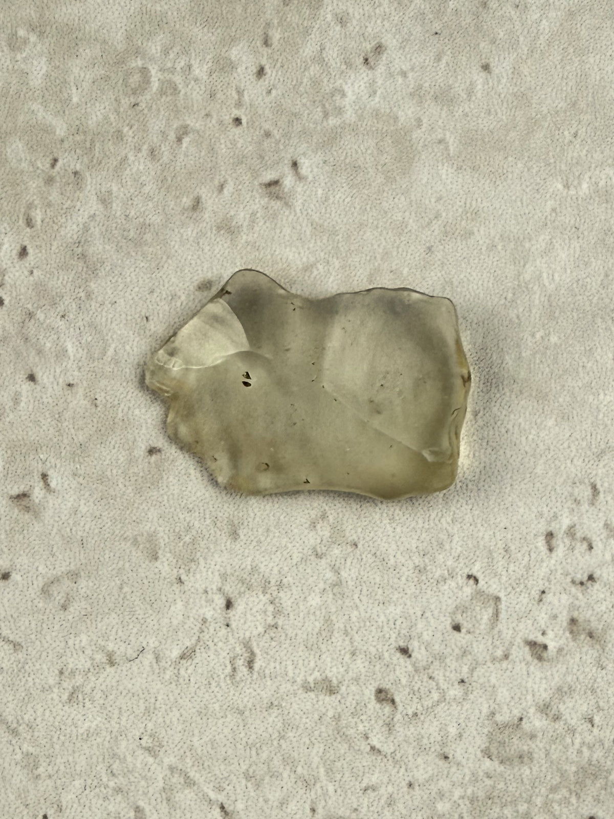 Natural Libyan Desert Glass, a broad flat piece of pale golden impact glass from the Sahara on a stone tile, one of a kind — Eternal Spirit