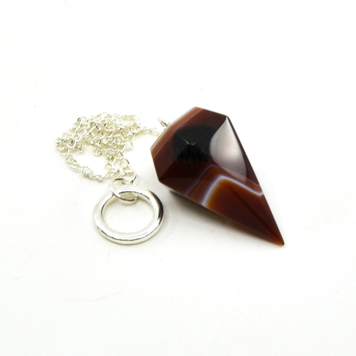 Close-up of Carnelian large faceted pendulum, fiery orange stone detail — Eternal Spirit