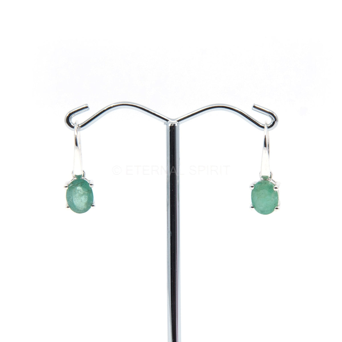 emerald faceted oval earrings with silver setting on white background — Eternal Spirit