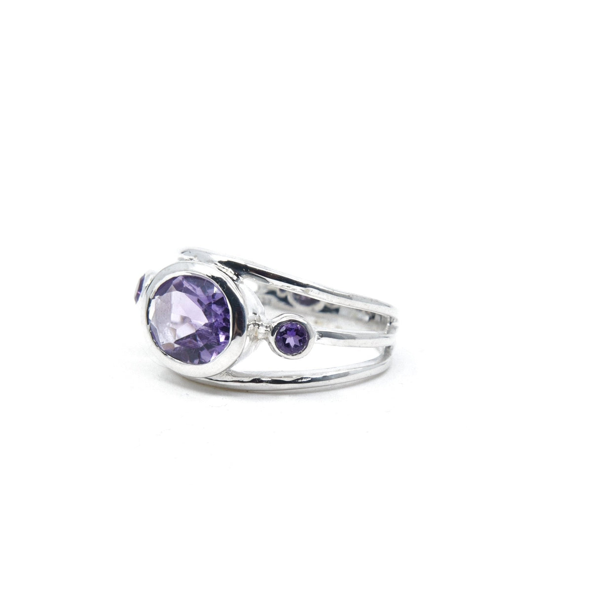 Amethyst ring #R550 angled to reveal its polished setting and silver band — Eternal Spirit