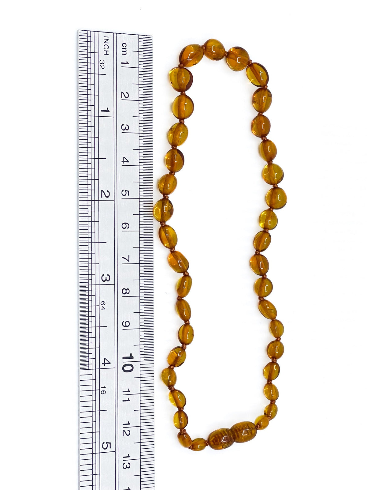 Amber teething necklace, polished bead detail close-up — Eternal Spirit