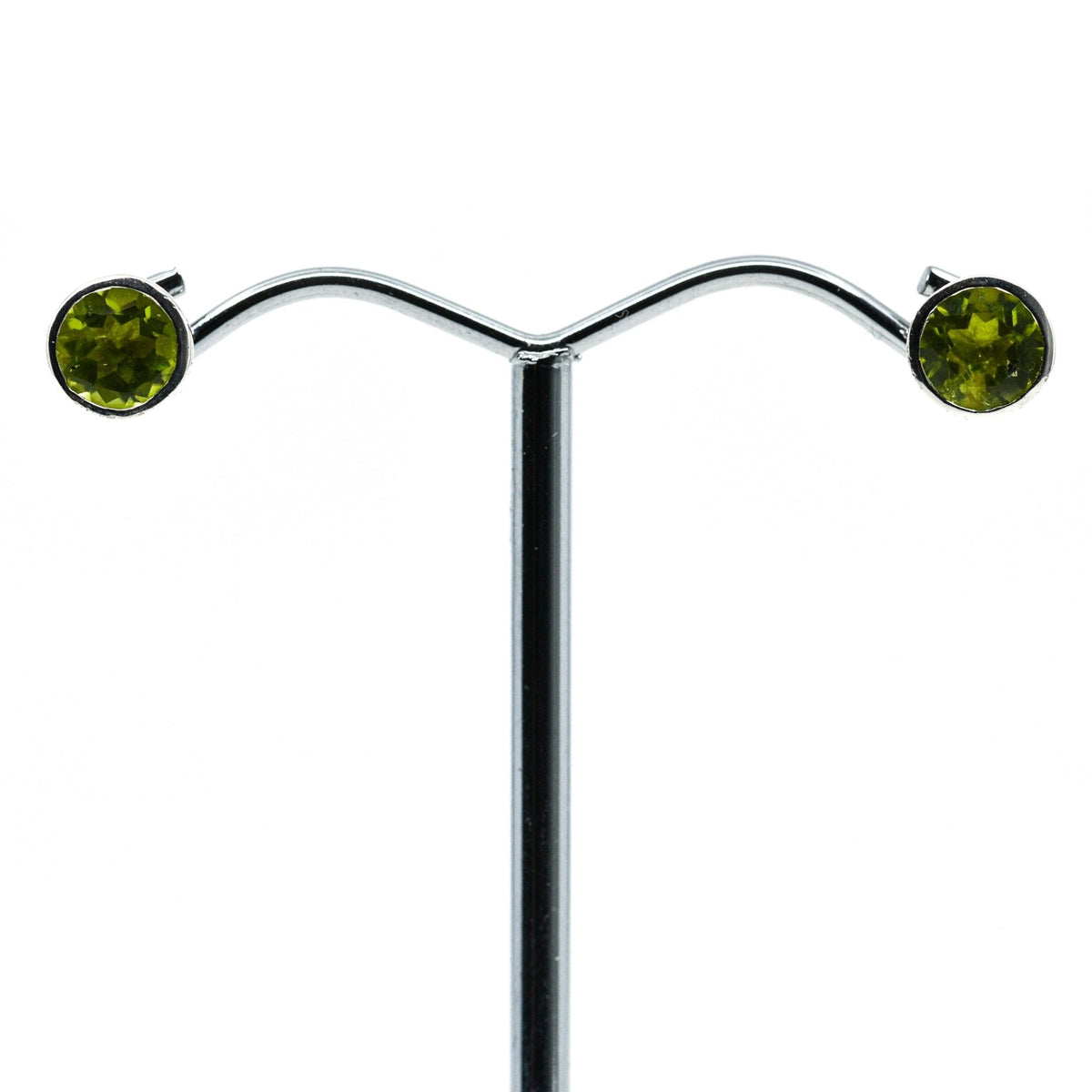 peridot faceted round studs earrings in silver setting, white background — Eternal Spirit