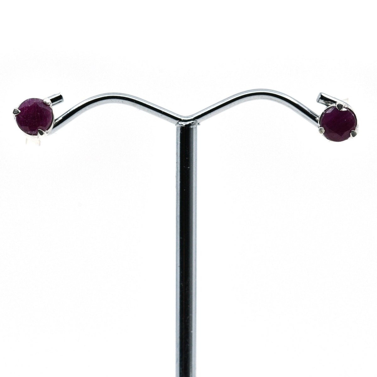 ruby faceted round studs earrings with silver setting on white background — Eternal Spirit