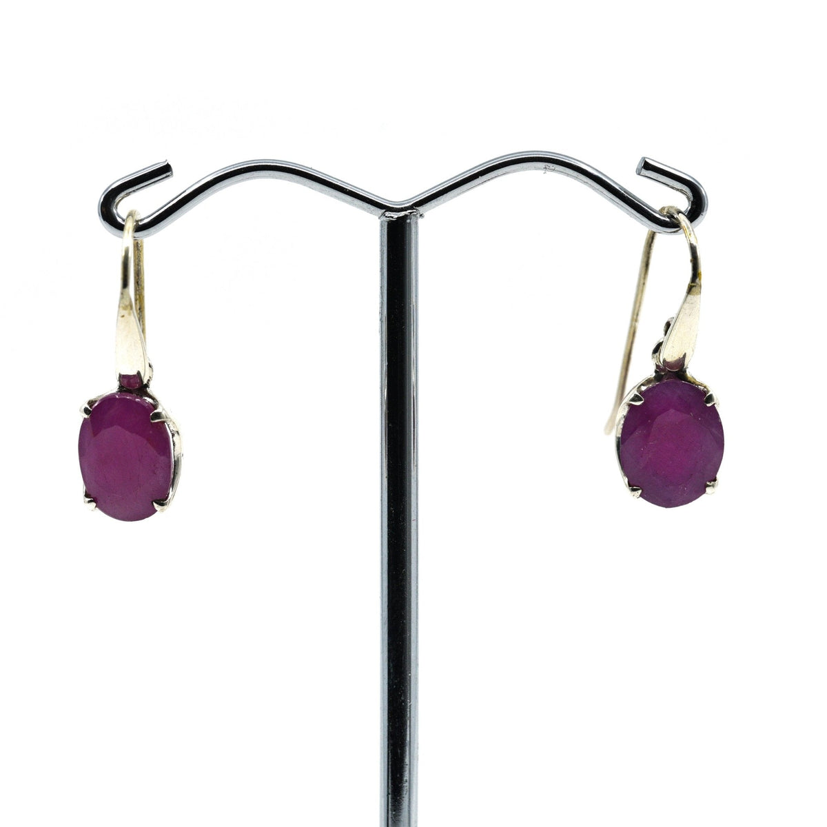 ruby faceted oval earrings with silver setting on white background — Eternal Spirit