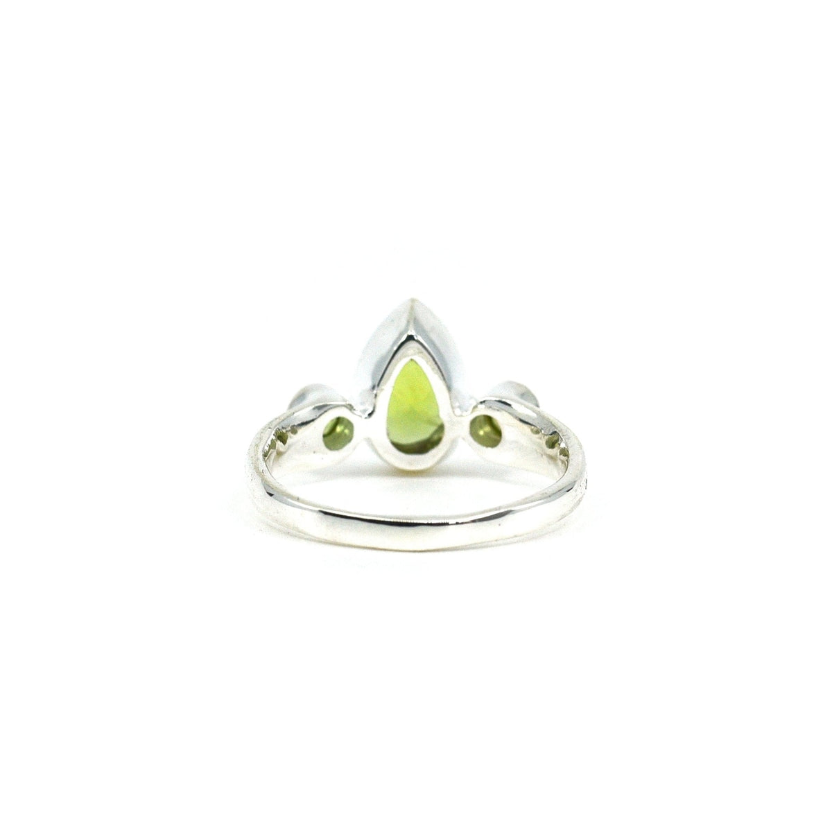 elegant side profile of Peridot ring #R697, the gemstone catching light — Eternal Spirit