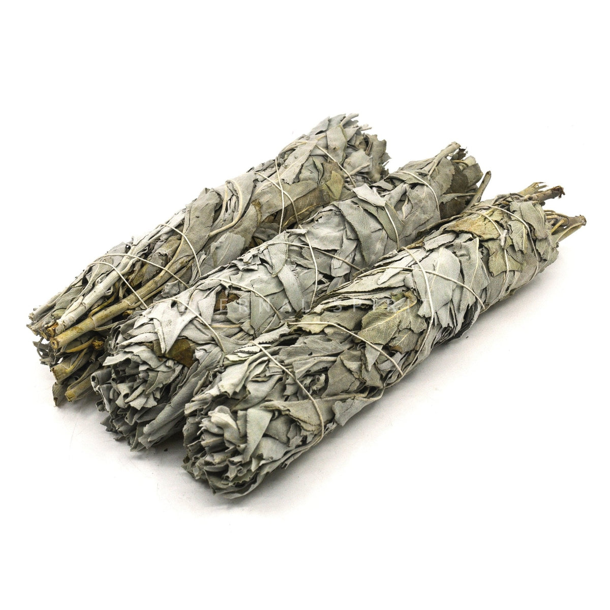 white sage smudge sticks (various sizes), aromatic smoke curling from a lit bundle — Eternal Spirit