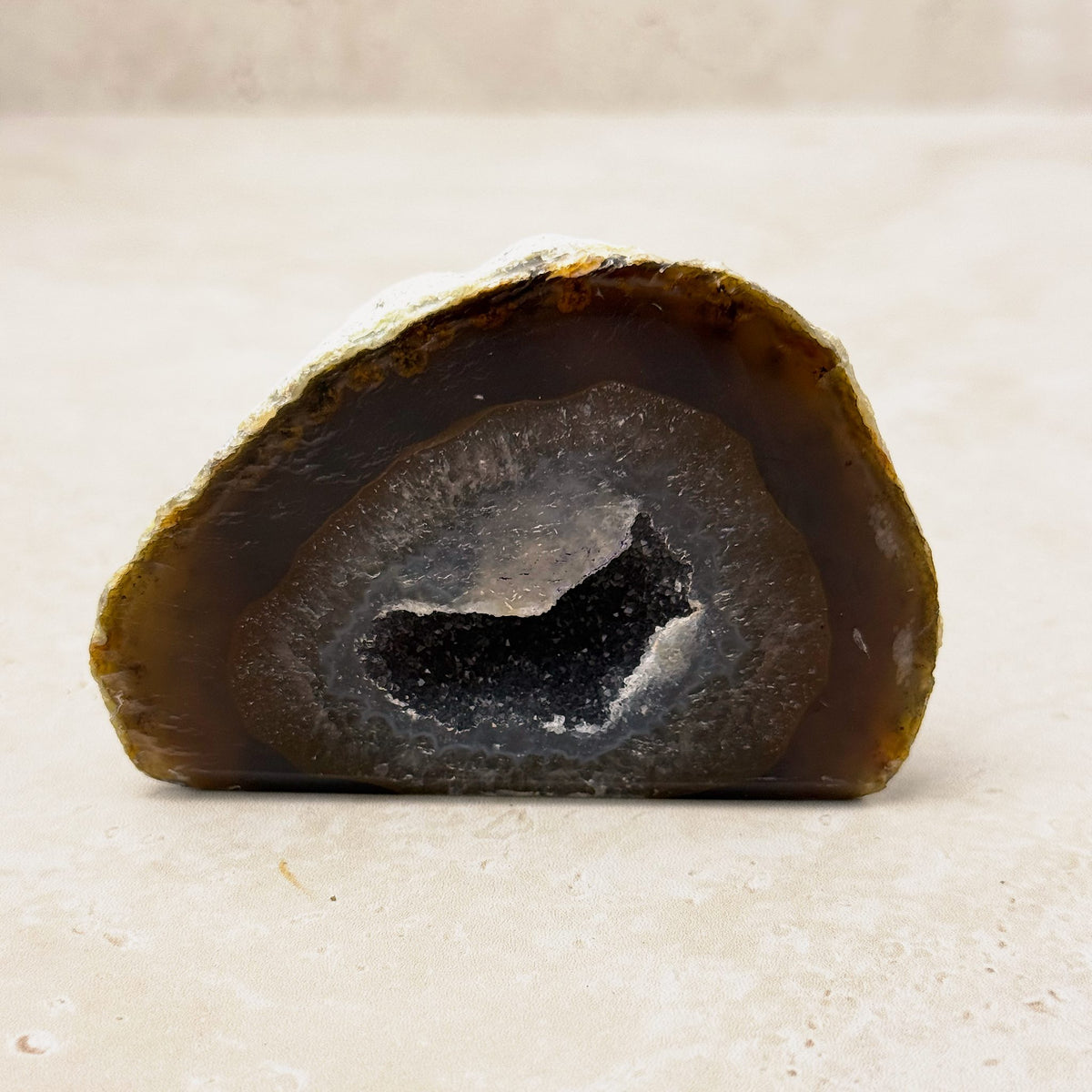 Agate crystal geode 9cm, honey and grey bands around a crystal hollow, front view — Eternal Spirit