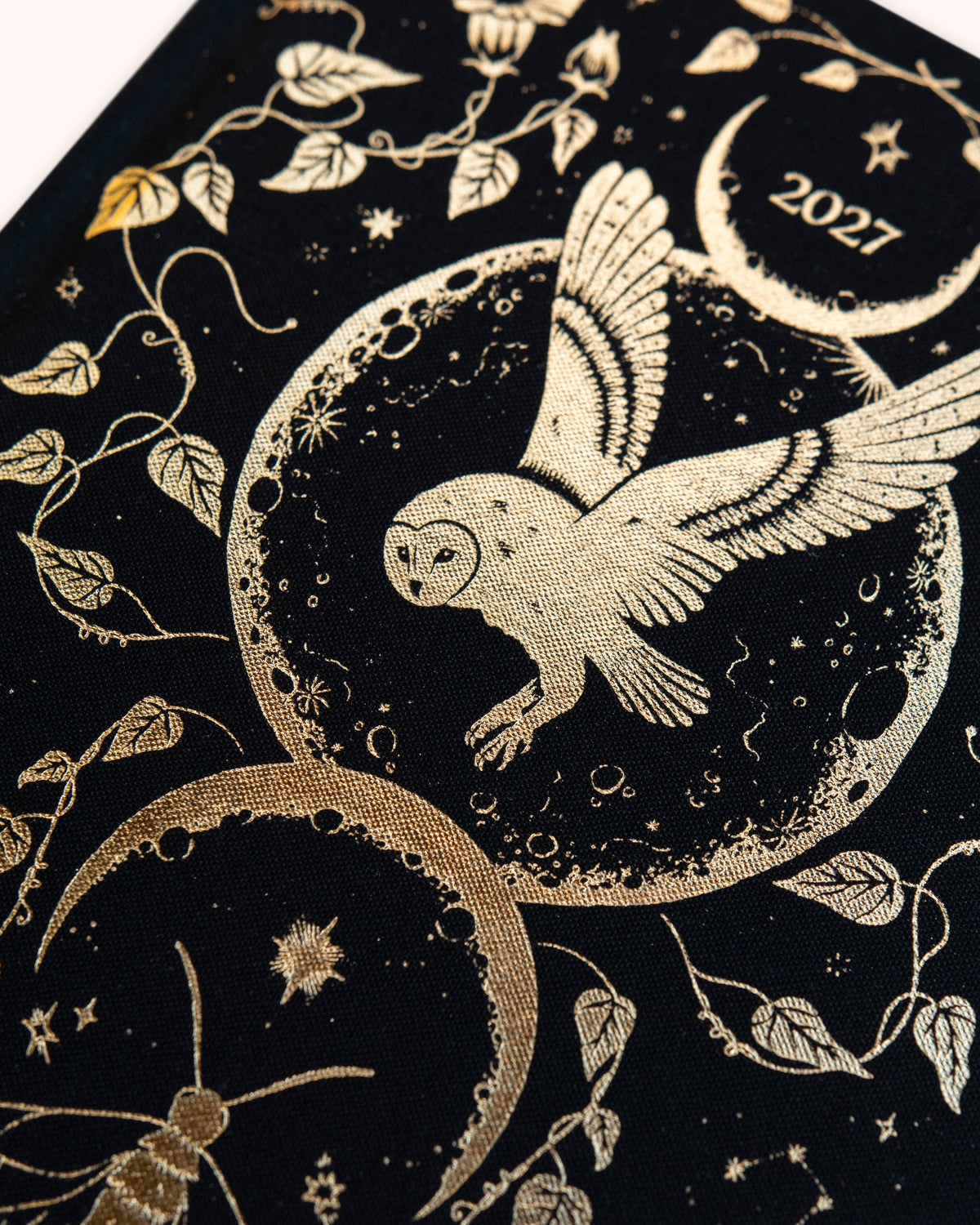 Dreamy Moons diary, close view of the Onyx Black cover's gold foil owl, moons and vines — Eternal Spirit