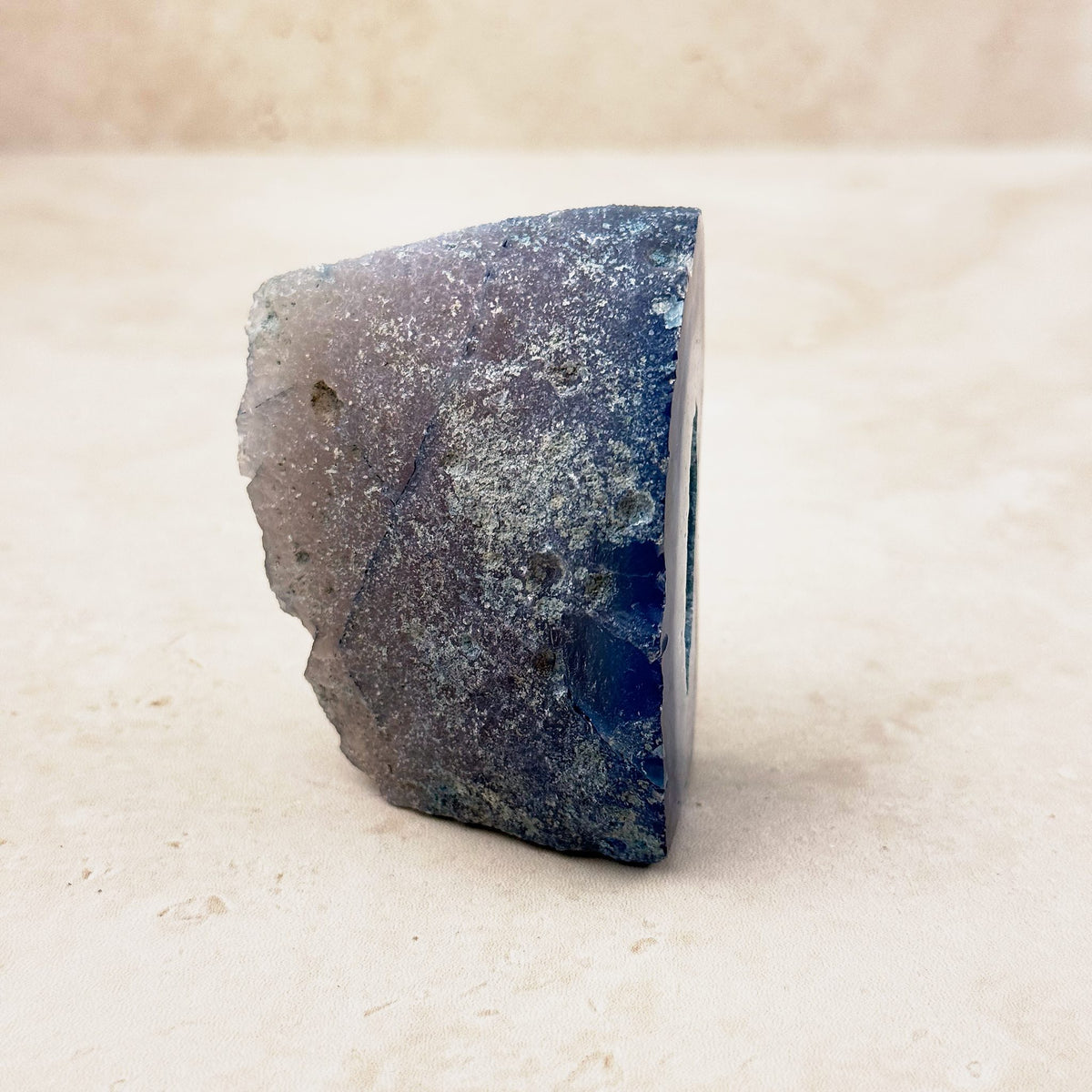 Dyed blue agate crystal geode 6cm, grey and blue outer rind, side view — Eternal Spirit
