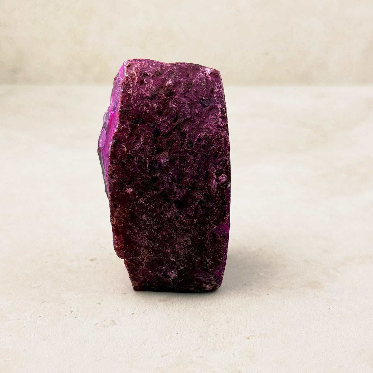 Dyed pink agate crystal geode 7.5cm, deep pink textured outer rind, side view — Eternal Spirit