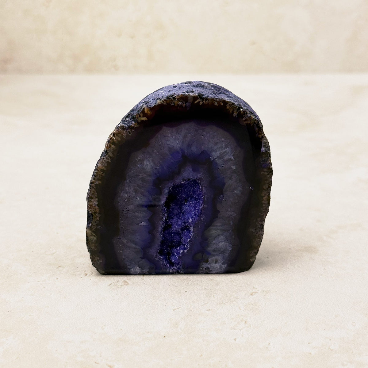 Dyed purple agate crystal geode 6cm, dark purple bands around a sparkling hollow, front view — Eternal Spirit