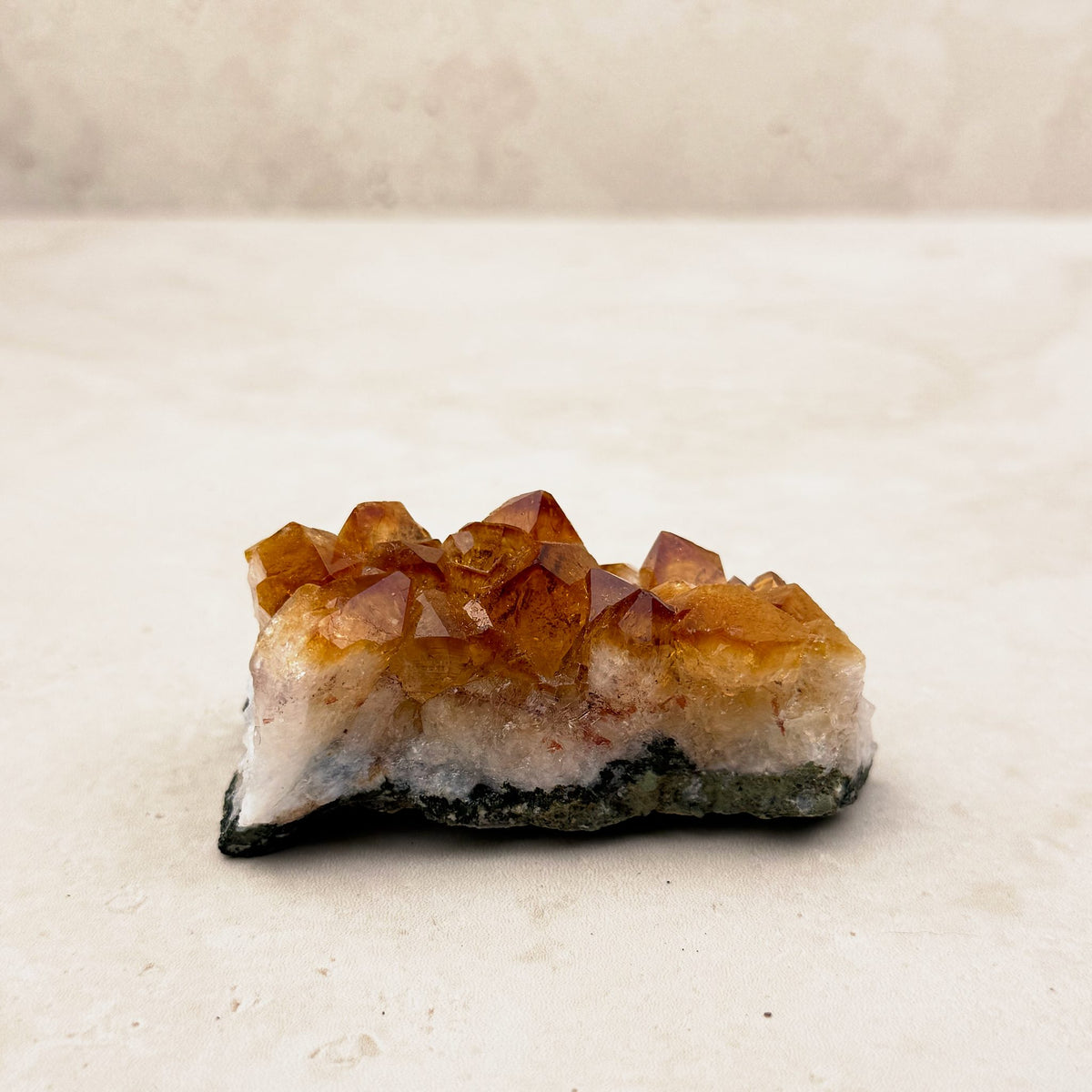 Heated citrine crystal cluster 7.5cm, small amber points on a white and grey base, low side view — Eternal Spirit