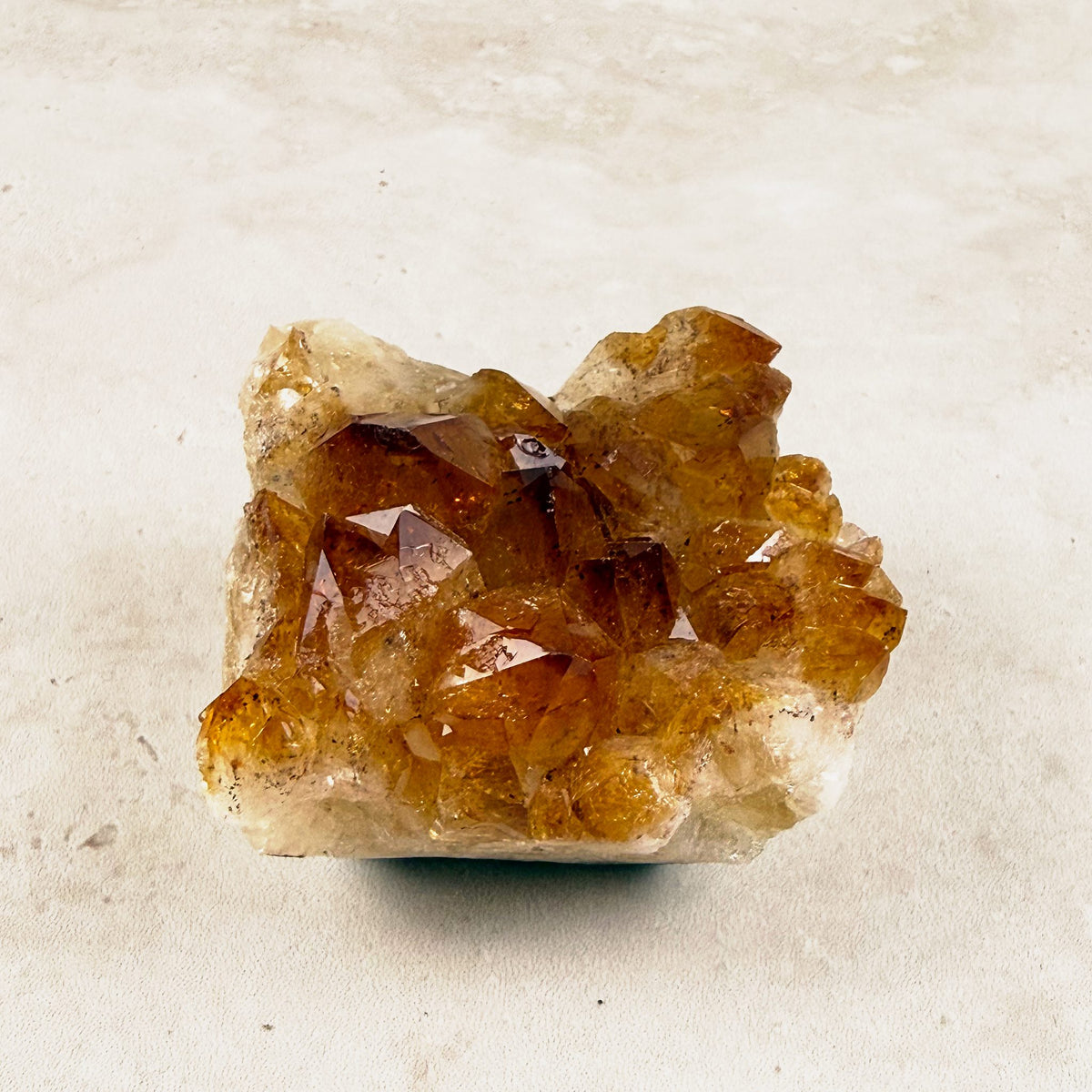 Heated citrine crystal cluster 6.5cm, compact amber points on a pale base, angled view — Eternal Spirit