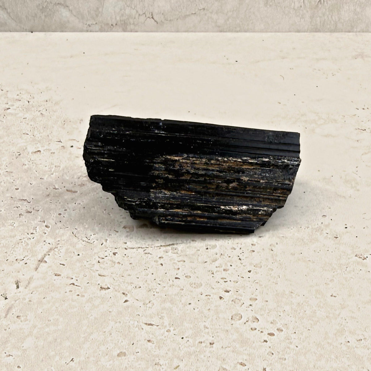 Rough black tourmaline crystal 8.5cm, long rectangular log, angled view — Eternal Spirit