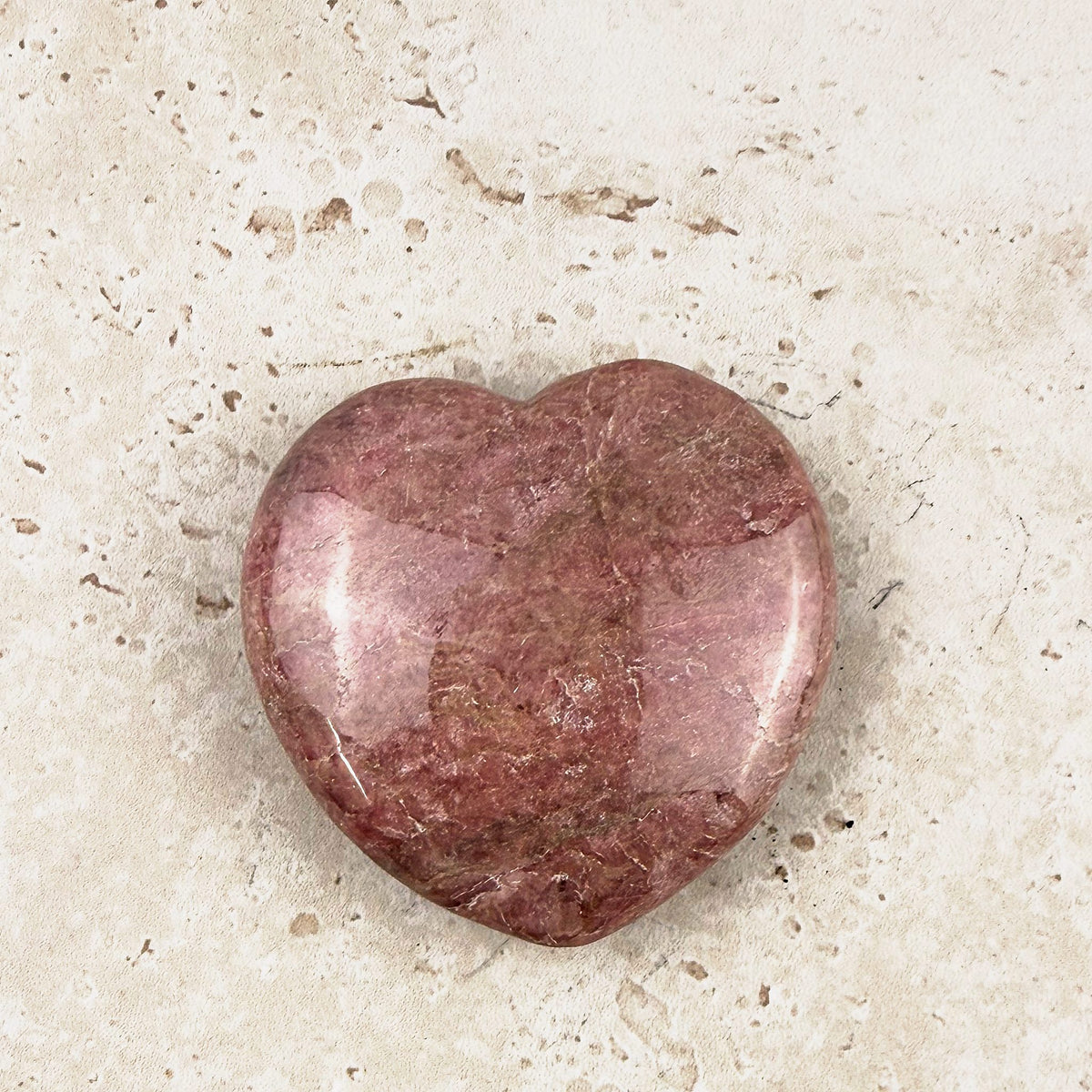 Mauve rhodonite crystal heart 5cm, soft mauve pink polished face, angled view — Eternal Spirit