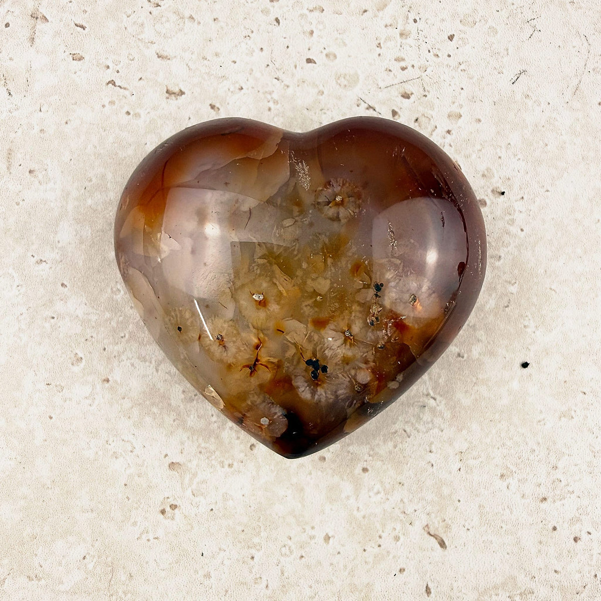 Speckled carnelian crystal heart 6cm, smoky amber edges and a creamy speckled centre, from above — Eternal Spirit