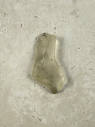 Natural Libyan Desert Glass, a long pale golden piece of impact glass from the Sahara on a stone tile, one of a kind — Eternal Spirit