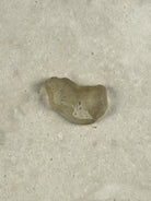 Natural Libyan Desert Glass, a small rounded piece of pale golden impact glass from the Sahara on a stone tile, one of a kind — Eternal Spirit