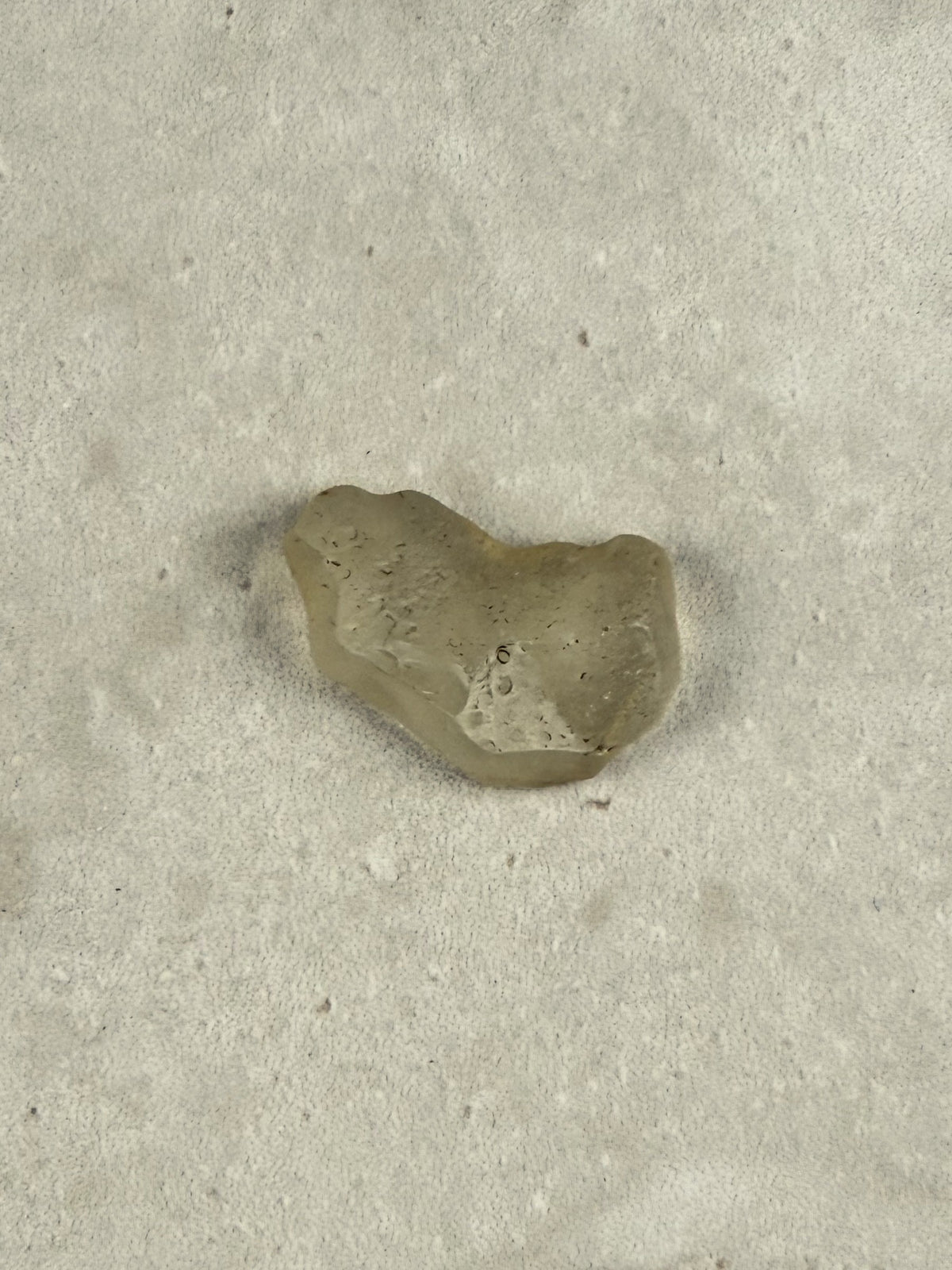 Natural Libyan Desert Glass, a small rounded piece of pale golden impact glass from the Sahara on a stone tile, one of a kind — Eternal Spirit