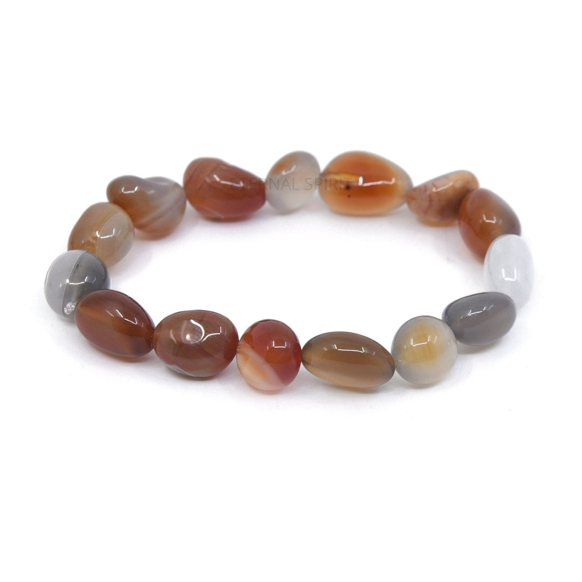 Carnelian tumbled bracelet resting on its crystal properties card — Eternal Spirit