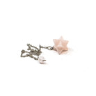 Close-up of Quartz (Rose) merkaba star pendulum, soft pink stone detail — Eternal Spirit