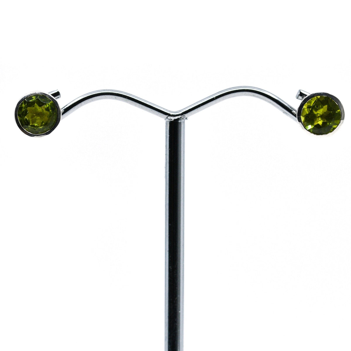 peridot faceted round studs earrings with silver setting on white background — Eternal Spirit
