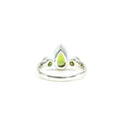 elegant side profile of Peridot ring #R697, the gemstone catching light — Eternal Spirit