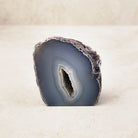 Agate crystal geode 6cm, grey and white bands around a narrow crystal hollow, front view — Eternal Spirit