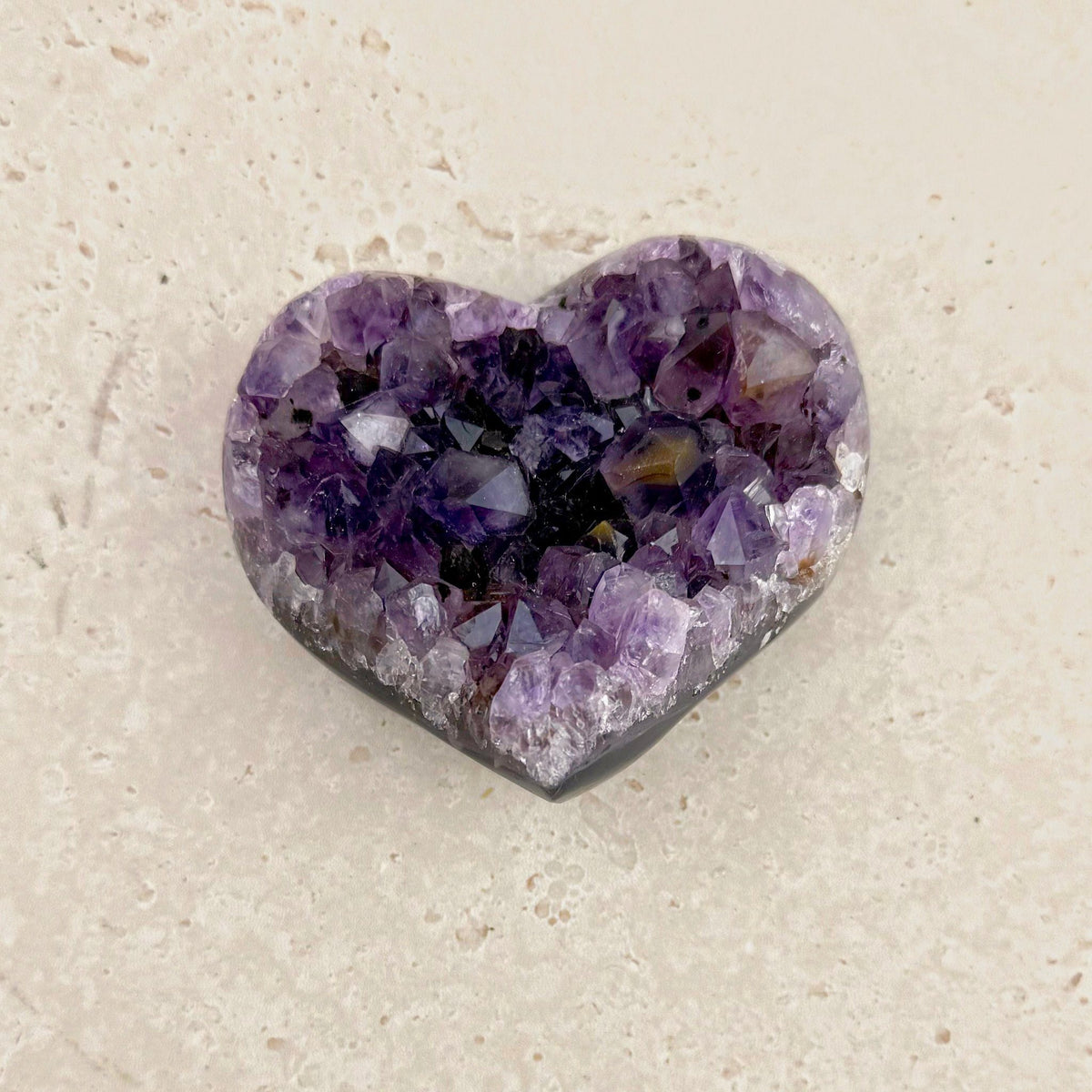 Amethyst crystal heart 7.5cm, dark purple fading to clear, seen from above — Eternal Spirit