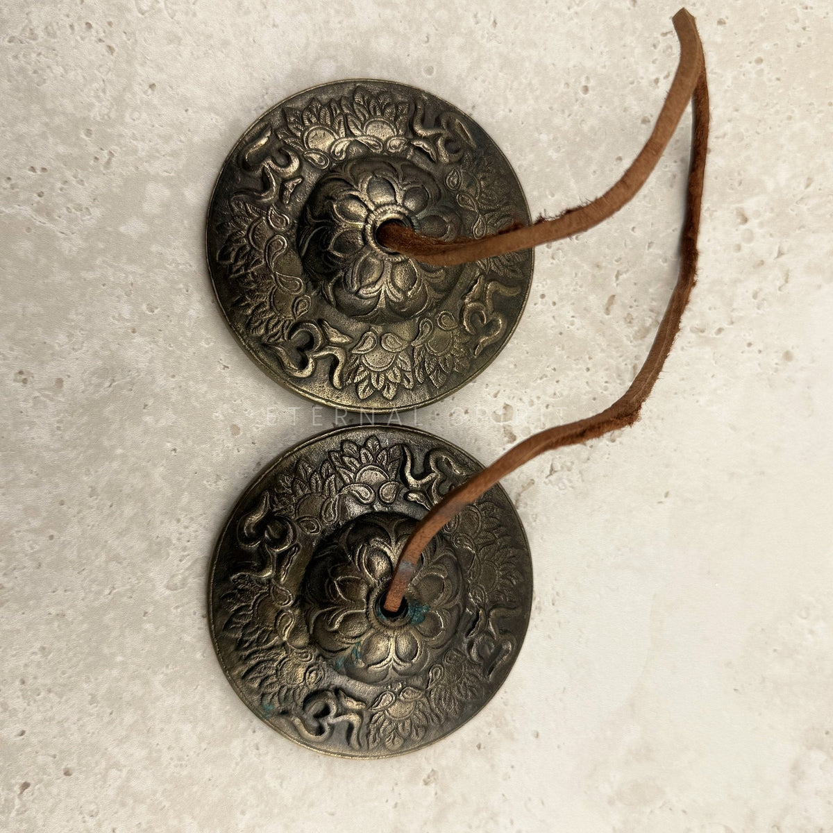 Bronze and brass Lotus tingsha cymbals 8cm, embossed lotus and Om symbols on a leather strap — Eternal Spirit