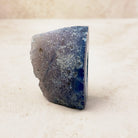 Dyed blue agate crystal geode 6cm, grey and blue outer rind, side view — Eternal Spirit