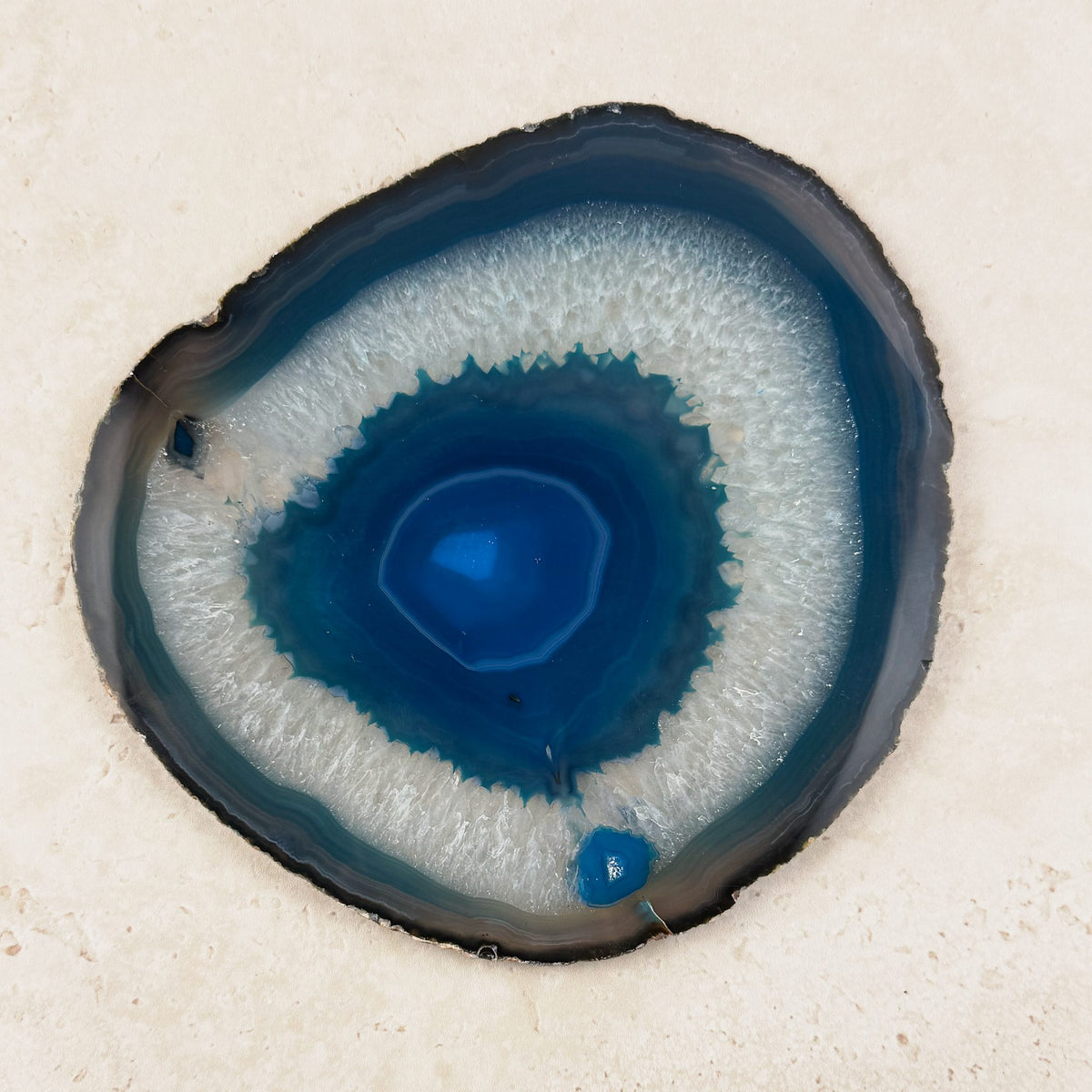 Dyed blue agate crystal slice 16.5cm, teal centre ringed by white and blue bands, viewed from above — Eternal Spirit