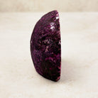 Dyed pink agate crystal geode 7.5cm, textured deep pink outer rind, side view — Eternal Spirit
