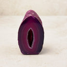 Dyed pink agate crystal geode 7.5cm, pink bands around a narrow crystal hollow, front view — Eternal Spirit