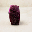 Dyed pink agate crystal geode 7.5cm, deep pink textured outer rind, side view — Eternal Spirit