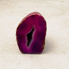 Dyed pink agate crystal geode 6.5cm, pink bands around a sparkling hollow, front view — Eternal Spirit