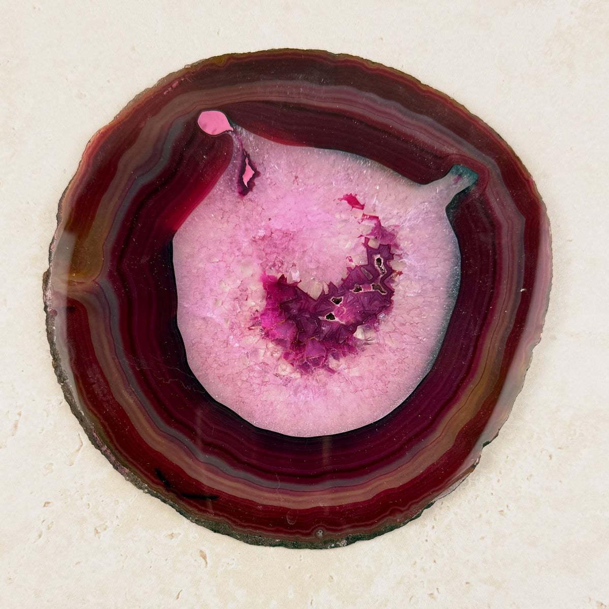 Dyed pink agate crystal slice 16cm, pink centre inside deep red and pink rings, viewed from above — Eternal Spirit