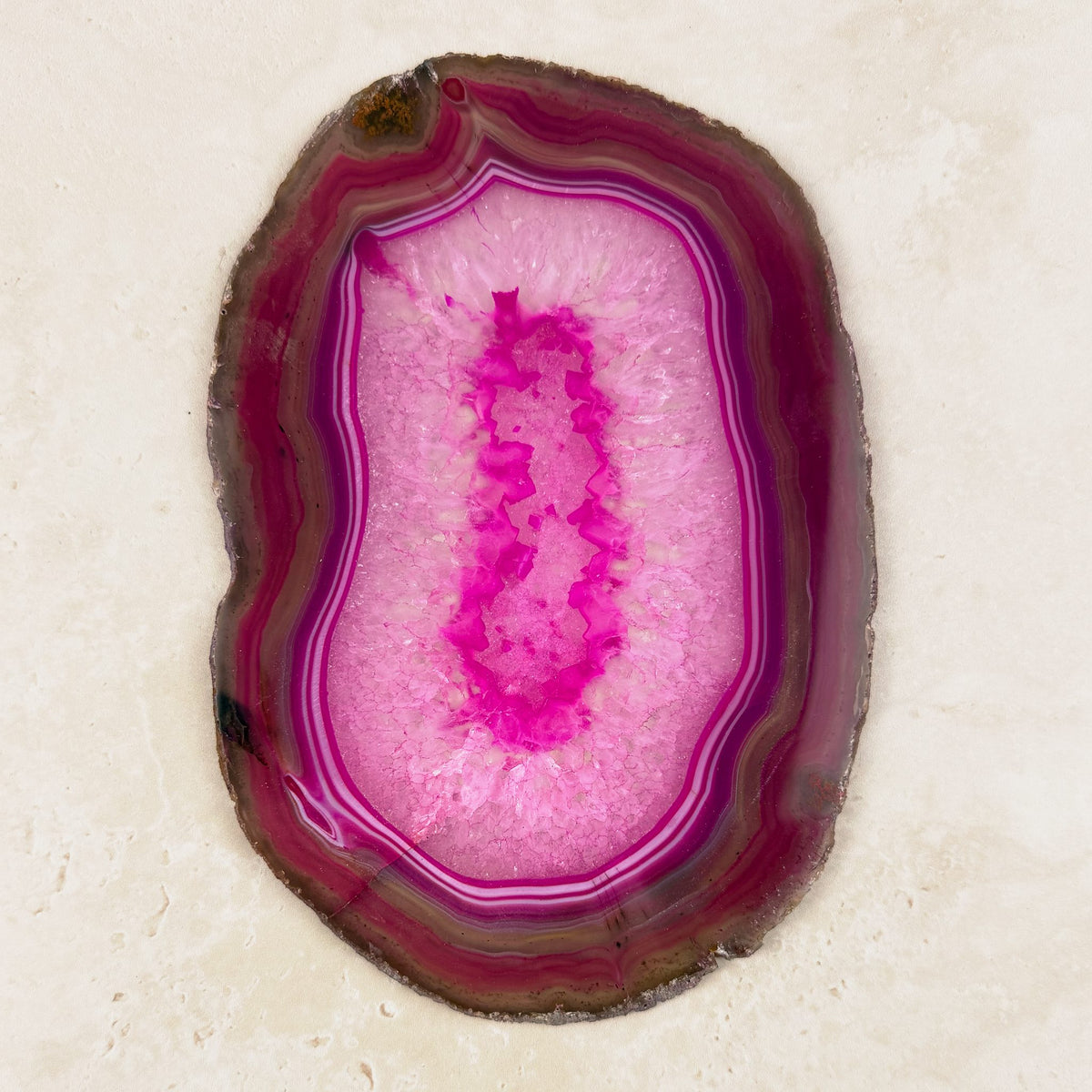Dyed pink agate crystal slice 19cm, long oval of pink and magenta bands, viewed from above — Eternal Spirit