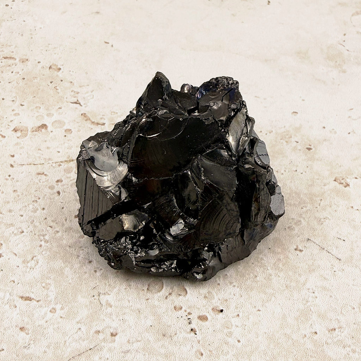 Glossy elite shungite rough crystal 5cm, sharp angles and a bright black shine, front view — Eternal Spirit