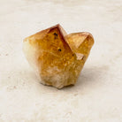 Heated citrine base cut crystal 5cm, amber tips on a white quartz base, front view — Eternal Spirit