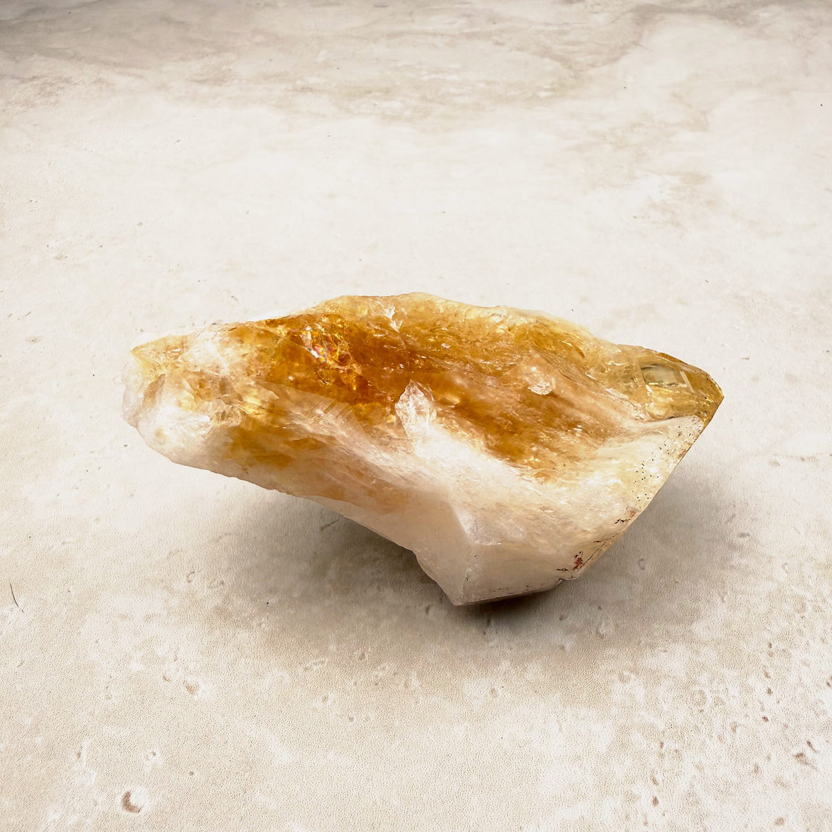 Heated citrine crystal point 9cm, amber tip and a white quartz body, lying on its side — Eternal Spirit