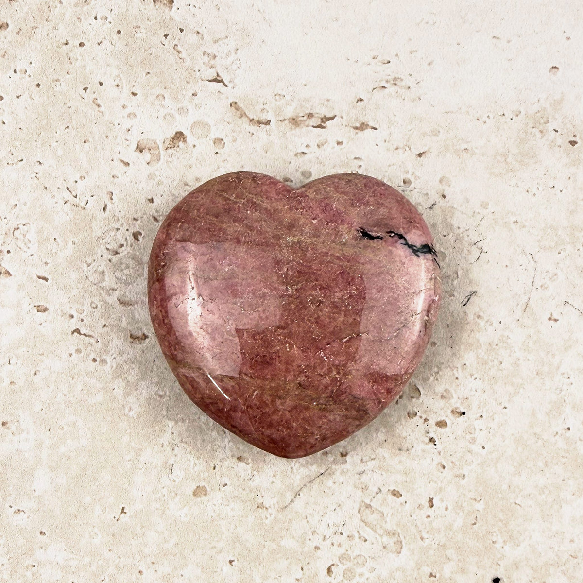 Mauve rhodonite crystal heart 5cm, muted mauve pink with a faint trace of black, from above — Eternal Spirit