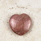 Mauve rhodonite crystal heart 5cm, soft mauve pink polished face, angled view — Eternal Spirit