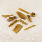 Natural copal amber pieces, ten honey-gold chips shown, one piece sold each — Eternal Spirit