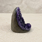 Base cut amethyst crystal 9cm, curved grey shell, side view — Eternal Spirit