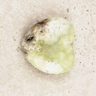 Prehnite crystal heart 5.5cm, lime green with a darker inclusion near the top, angled view — Eternal Spirit