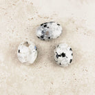 Rainbow moonstone crystal palm stones 4.5cm, three polished white stones with black flecks, from above — Eternal Spirit