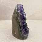 Base cut amethyst crystal 17.5cm, grey stone shell beside the crystals, side view — Eternal Spirit