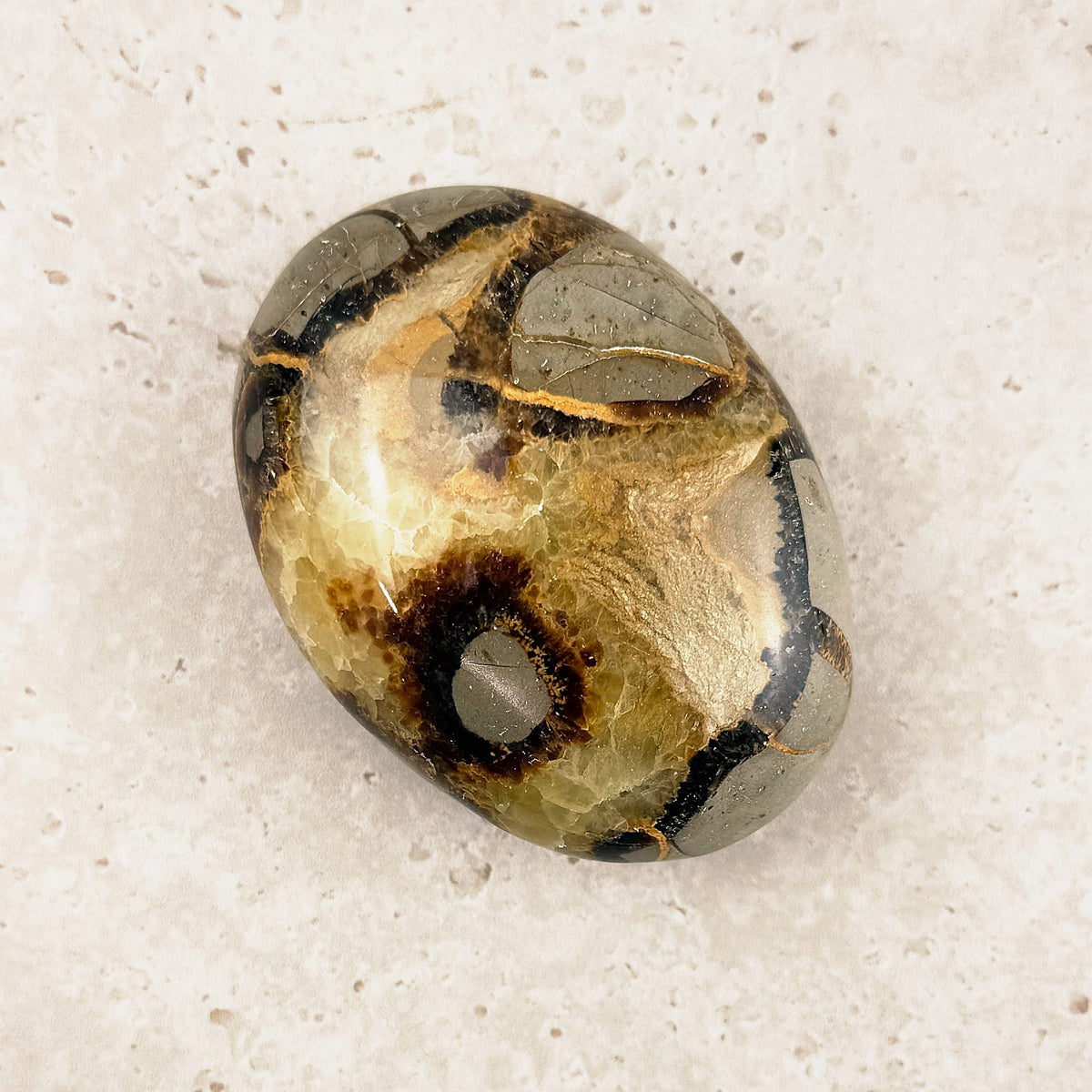 Septarian crystal soap stone 7cm, chocolate and honey veins in a polished oval, angled view — Eternal Spirit