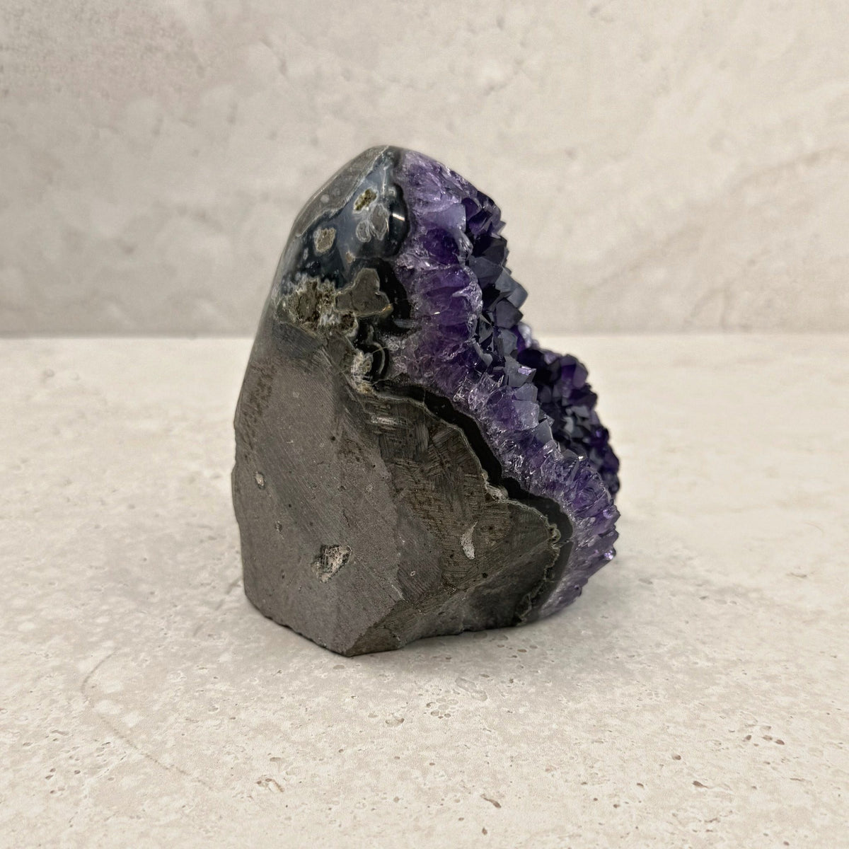 Base cut amethyst crystal 11cm, grey stone shell, side view — Eternal Spirit